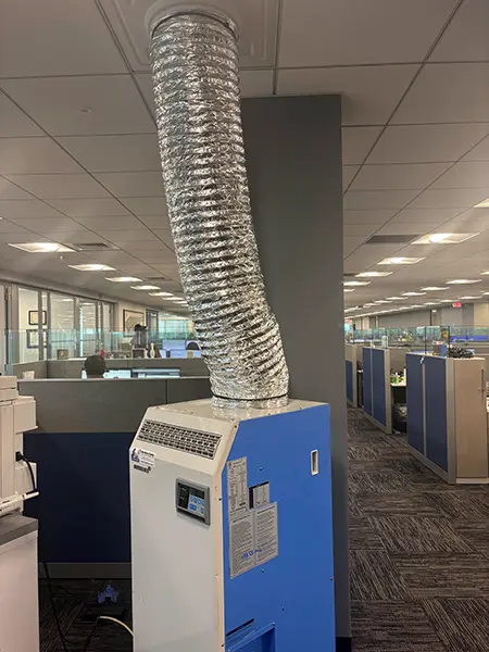 Temporary portable air conditioner in use in an office building.